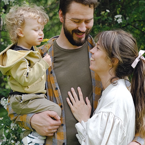 Photo of Man and Woman Holding Child