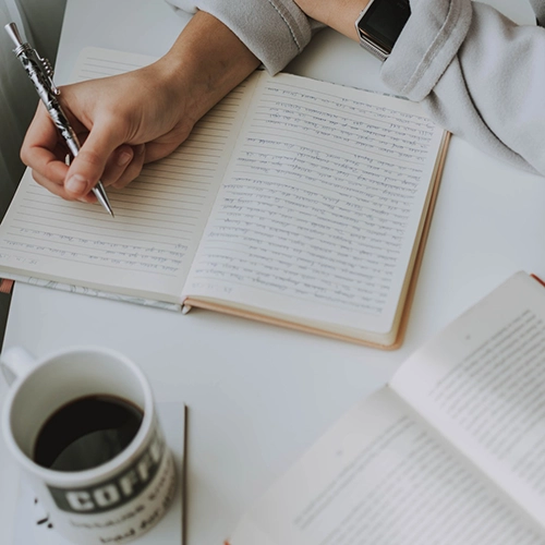 Woman Writing in Notebook