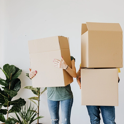 Couple Carrying Moving Boxes